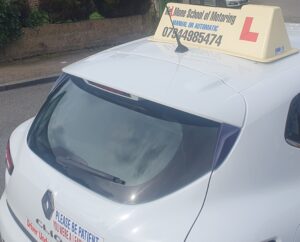 Driving instructor explaining road situations to learner drivers during a lesson